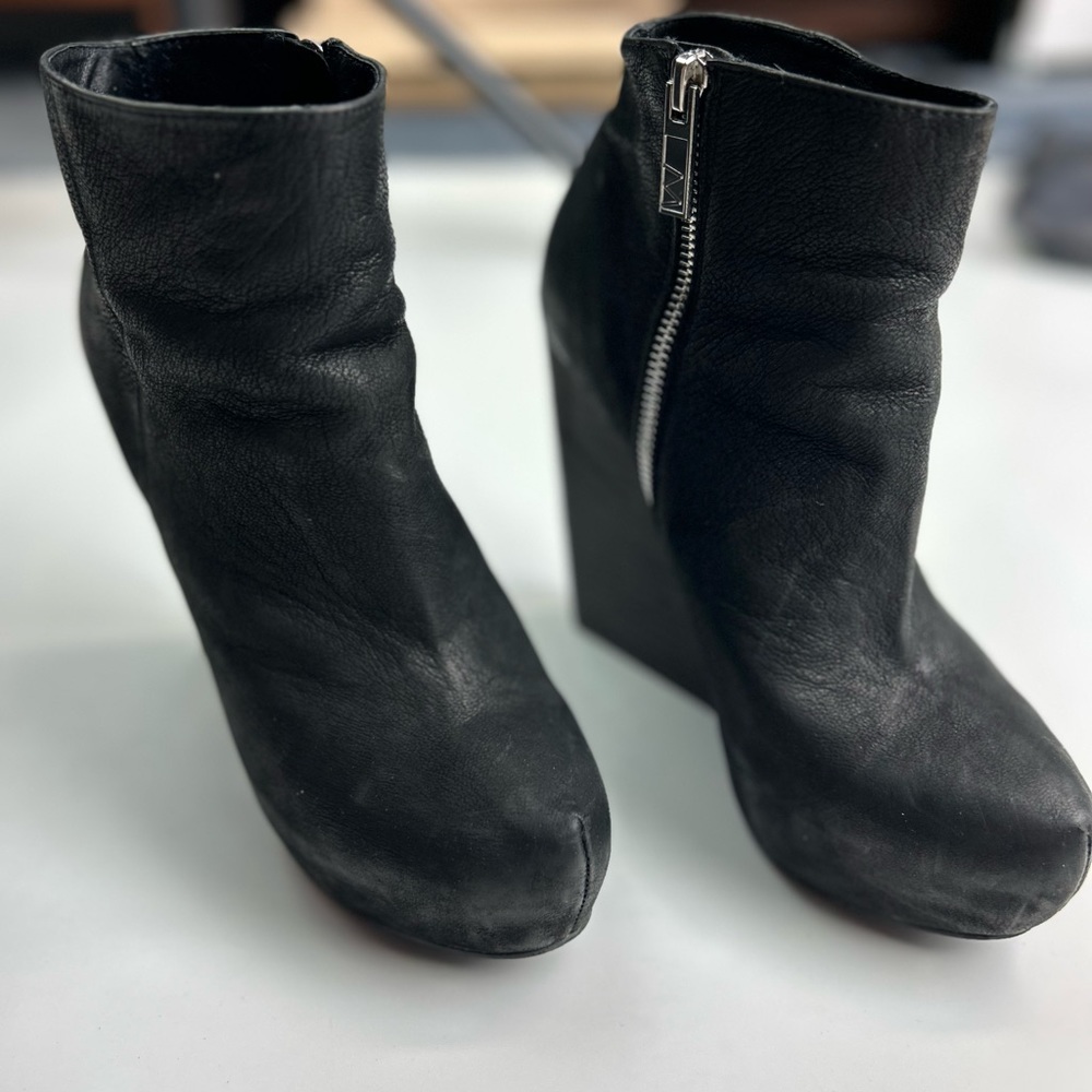 Soft gently distressed nubuc very high heel bootie. Side zip chunk wooden heel
